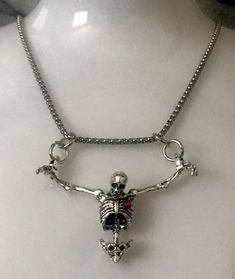 Embrace the darker side of fashion with our Hanging Skeleton Torso Necklace on a stainless steel 18" chain. This unique piece features a silver skeleton hanging from both wrists, adding a touch of Gothic flair to any outfit. You have the option to personalize your necklace by choosing between a skeleton with or without a striking red rhinestone heart accent. The skeleton's head is elegantly tilted forward, enhancing its macabre charm. Perfect for Halloween or as a statement accessory, this neckl Hanging Skeleton, Heart Skeleton, Skeleton Necklace, Skeleton Head, Beating Heart, Black Gift Boxes, Rhinestone Heart, Red Rhinestone, Black Gift