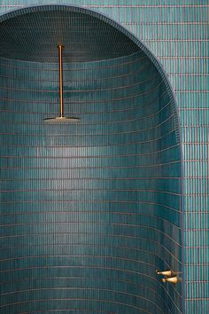 a blue tiled bathroom with gold fixtures