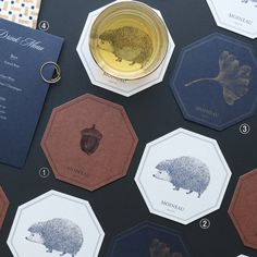 there are many different types of coasters on the table, including one with a hedgehog