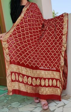 A traditional art work of Bandhej inspired gharchola checks design called as khaddi georgette style on pure georgette fabric. The dupatta is embellished with zari checks and handmade bandhej all over. The dupatta is a good to go item for Indian festives and weddings. In many parts of India it is gifted to the bride as a blessing. We have done the roll press and also the piku(ends binding of the dupatta threads to give it a finished touch) Unstitched Bandhani Print Dupatta In Chinon, Unstitched Chinon Dupatta With Bandhani Print, Chinon Dupatta With Bandhani Print, Unstitched Bandhani Print Georgette Dupatta, Navratri Bandhani Print Georgette Dupatta, Bollywood Style Georgette Dupatta With Bandhani Print, Bollywood Style Bandhani Print Georgette Dupatta, Festival Georgette Traditional Wear With Bandhani Print, Festival Traditional Wear With Bandhani Print In Georgette