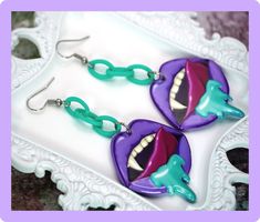 Handmade pastel goth style earrings with purple salivating acrylic Vampire Mouth charms and stainless steel earring hooks.As with all of my products, these earrings are only made in a small batch (one pair) and will not be made again. Read my shop's "About" section for more details.Details:Earring metal: Stainless steelEarring Drop Length: 3.5” in. (8.9 cm)Earring Width: 1.38" in. (3.5 cm)Includes: Pair of earrings with silicone stoppersPlease be aware that color shades can vary depending on screen type/device/brightness settings used to view the listing. Creepy Vampire, Halloween Core, Pastel Goth Earrings, Pastel Goth Style, Vampire Mouth, Vampire Earrings, Spooky Earrings, Goth Earrings, Pastel Goth Fashion