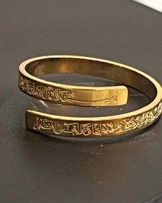 "Elegant and beautiful high quality Accessories:  The ring has \"ayatul-kursi\" \"  Throne Verse\" engraved in Arabic | gold Color | Islamic  Gift | Islamic  ring adjustable  gold Color Alloy ring for women. For your personal use or as a great gift.  Perfect for islamic accessories , featuring Adjustable ring.  Material: High quality alloy metal one size ring that is adjustable" Gold Adjustable Engraved Spiritual Ring, Adjustable Gold Engraved Spiritual Ring, Adjustable Gold Engraved Ring, Gold Engraved Adjustable Ring, Traditional Adjustable Engraved Ring For Anniversary, Traditional Adjustable Engraved Ring, Traditional Adjustable Engraved Etched Ring, Adjustable Traditional Engraved Etched Ring, Spiritual Adjustable Engraved Wedding Ring