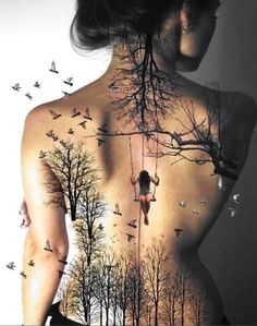 the back of a woman's body with trees and birds on it