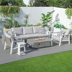 an outdoor living area with furniture and plants