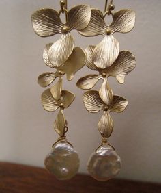 On sale gold or silver orchid earrings, highly detailed shimmering gold petals form pretty floral earrings. made with natural keishi pearls. vermeil earwires. 2.25''long. **available in silver** Please convo me if you would like to customize this piece or order multiples for your bridal party , I would love to hear from you! Gold Petal Earrings For Party, Gold Flower Chandelier Earrings Elegant Style, Gold Flower-shaped Elegant Chandelier Earrings, Elegant Gold Flower Chandelier Earrings, Elegant Gold Petal Earrings, Elegant Gold Petal-shaped Earrings, Handmade Gold Flower Earrings For Wedding, Yellow Gold Flower Pearl Earrings For Wedding, Elegant Gold Petal Flower Earrings