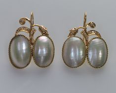 "Timeless and elegant floral design earrings  are made of Mabe pearls, 14K gold, and diamond in 1960s  The high-quality bezel set Mabe pearls  measure approx. 16 X 12 mm. The single cut diamonds, totaling approx. 0.10 CTW, add a touch of sparkle and glamour,  making them perfect for special occasions or everyday wear. The earrings are 1 1/4\" high with hooks, 1\" wide. They are hallmarked 14K and a designer mark J0JT17. Total weight is 11 grams. Excellent vintage condition. Mabe pearls are a type of blister pearl  that is formed on the inside of the shell of a mollusk.  They are known for their large size and iridescent luster." Elegant Oval Pearl Earrings With High Luster, Oval High Luster Pearl Earrings For Formal Events, Formal High Luster Oval Pearl Earrings, Formal Oval Yellow Gold Pearl Earrings, Luxury Oval Pearl Earrings For Formal Occasions, Wedding Yellow Gold Oval Pearl Earrings, Antique Yellow Gold Pearl Earrings For Formal Occasions, Antique Clip-on Pearl Earrings For Formal Occasions, Exquisite Yellow Gold Pearl Earrings For Formal Occasions