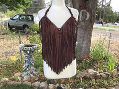 Beautiful top quality buckskin leather halter top. Dark brown with fringe. Native American Indian inspired. This top feels so good on your skin it's as if it is caressing you. This top can be adjusted to fit most bra sizes. The form that it is on is a very small chest and it fits. It also fits me and I am a D. This top should fit a double D. If you are interested please message me your bust size. Wrap a measuring tape around fullest part of bust and all the way around you and give me that measurement. This top will look good with anything! Wear it with pride and know everyone will be checking you out! If you want any beads on top let me know and I can add some for you. Thank you for visiting my shop! Leather Halter Top, Leather Halter, Womens Halter Tops, Indian Inspired, Halter Tops, Measuring Tape, Small Chest, Native American Indians, American Indian