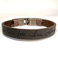 "A personal touch increases the value of any gift specially of these sentimental beautiful long lasting handwriting bracelets. Transform your loved one's handwriting into a beautiful keepsake, or your OWN! Personalized the outside, or on the inside of the bracelet with a signature, handwriting, or drawing in any language of your choice. The actual handwriting has been burned into the leather and will not fade away with wear., The inside engraving can not be seen by anyone but can be only seen by the wearer.. ### For this bracelet Can be engraved the outside OR inside with the Actual HANDWRITING and with regular font request on the opposite side of the band if you select (Out-In),  in the drop down menu. ### If you do not have handwriting, we can also use your selected font for the sample f Adjustable Signature Style Bracelet For Anniversary, Adjustable Laser Engraved Bracelets For Everyday Wear, Meaningful Adjustable Bracelets With Engraved Text, Stamped Leather Bracelet As Gift, Hand Stamped Brown Bracelets For Gifts, Hand Stamped Brown Bracelets As Gift, Handwriting Bracelets, Custom Signature, Personalized Leather Bracelet