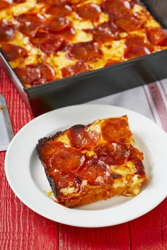 a slice of pepperoni pizza on a plate next to a casserole dish