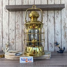 an antique brass lamp on a wooden shelf next to a sign that says the natural