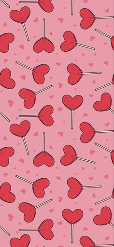 a pink background with hearts and lollipops on sticks in the shape of hearts