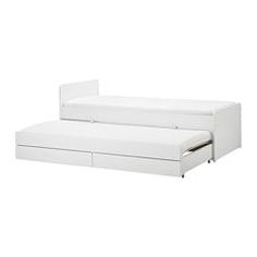 a white couch bed with two drawers on it