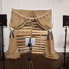 a photo studio setup with wooden pallets and drapes for the curtained window