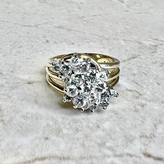 CLEARANCE - 40% OFF! A magnificent and fine vintage diamond cluster cocktail ring crafted in 14 karat yellow and white gold. Circa 1970. It is set with 19 round diamonds weighing approximately 1.35 CTTW. The stones are approximately G-H color, SI clarity. Stamped 14K. Weighs 8.5 grams. Size 6.75 US / N UK. > Resizing not included. This ring can be resized to fit most fingers. Please contact us for details. W: 15.5 mm. Birthstone: April. Condition: Very good. Minor scratches throughout metal. - F Cluster Rose Cut Diamond Ring For Anniversary, Diamond Cluster Ring With Rose Cut Diamonds, Cluster Diamond Ring With Rose Cut For Anniversary, Heirloom White Cluster Ring, Antique White Cluster Ring With Brilliant Cut, Heirloom Cluster Ring In Diamond White, Yellow Gold Cluster Diamond Ring For Anniversary, Yellow Gold Diamond Cluster Ring For Anniversary, Anniversary Yellow Gold Cluster Diamond Ring