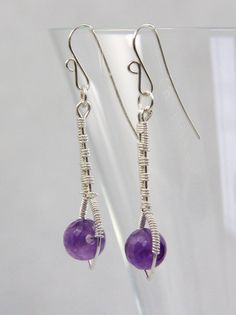 Faceted Amethyst beads (6mm) are encased in an inverted sterling silver wire teardrop.  The drop is at the end of a silver stem, all of which has been carefully woven together, in an intricate weave pattern, with sterling silver wire.  The ear wires are handcrafted of 22 gauge sterling silver wire. The total length of the earring is 1 3/4 inches (4.4 cm) Please see the 5th photo for an indication of size/scale.Please feel free to ask questions and thank you for visiting!!listing/263081997/red-ga Gemstone Bead Drop Earrings For Gifts, Silver Gemstone Bead Round Earrings, Sterling Silver Gemstone Bead Earrings, Silver Round Gemstone Bead Earrings, Silver Gemstone Beads Earrings, Sterling Silver Earrings With Round Gemstone Beads, Spiritual Gemstone Bead Drop Earrings, Sterling Silver Jewelry With Round Birthstone Beads, Sterling Silver Gemstone Beads Dangle Earrings