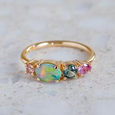 Our splice cluster ring has been set with a solid grey crystal opal from Lightning Ridge and shades of pink and teal sapphires. Band width 1.5mm. Gold weight in 14ct 3.1g (approximately). Please note, we will match the opal as close to the image as possible, but each opal is unique and may vary in appearance and colour Crystal Opal, Lightning Ridge, My Size, Opal Crystal, East West, Jewelry Inspo, Perfectly Imperfect, Dream Jewelry, Black Opal