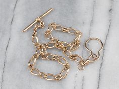 This vintage curb link watch chain is in beautiful condition! Although originally intended to hang from a waistcoat, this chain is a great length for wearing as a necklace. You could even add charms if you so wished! Metal: 14K Yellow Gold Width of Chain: 6.5 mm Length of Chain: 15 Inches Marks: "14" Stamped on the clasp Vintage Gold Watch, Pocket Watch Chain, Pocket Watches, Watch Chain, Curb Chain, Gold Watch, Pocket Watch, Vintage Gold, Jewelry Watches