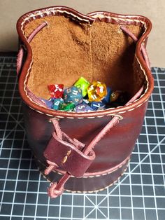 This is a handmade leather dice bag for your tabletop adventures. The colors in leather we have to offer varies Leather Pouch With Case Included For Gift, Leather Bucket Pouch As Gift, Gift Leather Pouch With Case Included, Leather Pouch Bag With Pen Holders, Leather Dice Bag, Ditty Bag, Dice Bag, Savannah Ga, Coin Purses