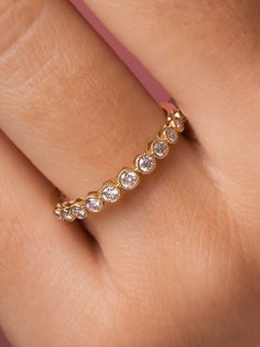 a woman's hand with a diamond ring on it