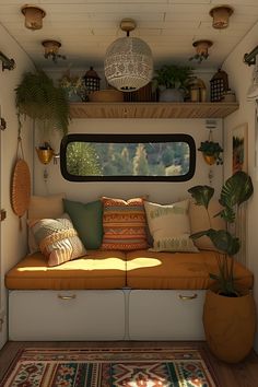 the inside of an rv with plants and pillows