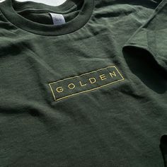 Embroidered onto a 100% cotton garment with a golden thread for a classic look. Soft-washed and garment-dyed as a forest green, the t-shirt makes for a durable staple and memento of Jungkook's first solo endeavor. This will be the softest tshirt you own! Please refer to the size guide in the listing for shirt measurements. If you have any questions or if there's a specific size/shirt color you would like but it's out of stock, please message me! I'll try my best to accommodate :) Gold Long Sleeve Cotton Shirt, Green Long Sleeve T-shirt With Embroidered Logo, Gold T-shirt With Screen Print For Streetwear, Green Cotton Band Merch Top, Green Band Merch Top For Fall, Gold Crew Neck T-shirt For Fall, Gold Crew Neck Cotton T-shirt, Gold Crew Neck Cotton Top, Relaxed Fit Gold Cotton Top