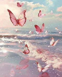 many pink butterflies flying over the water