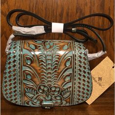 *Nwt-Patricia Nash-Light Tooled Turquoise-Finch Crossbody Bag-$169: *Description: Designed To Suit Your Weekday-To-Weekend Needs, The Finch Has A Lovely Curved Profile, Evoking The Laid-Back Feel Of The Countryside With Its Classic Equestrian Shape, Elegant Tooled Leather, & Whipstitched Edges. It Also Fits In With The Sophisticated Poise Of The City. A Unique Pull-Tab On The Flap Allows For Easy Opening Into A Convenient Interior With Two Main Compartments & The Adjustable Crossbody Strap Lets Leather Lacing, Brushed Nickel Hardware, Grape Leaf, Leaf Logo, Tooled Leather, Turquoise Color, Leather Tooling, Pull Tab, Crossbody Strap