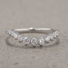 a white gold ring with five diamonds on it