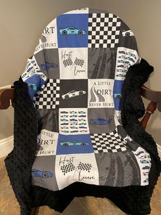 a chair with a blanket on it that has cars and checkered squares all over it