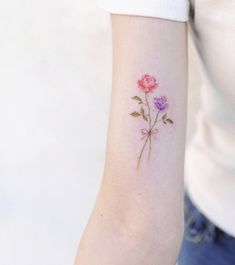 a woman's arm with three roses on it