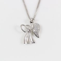 "LarkKing LK13018 Sterling silver angel necklace, angel wing necklace, angel heart charm, silver angel pendant, angel necklace for women, angel for gift, Christian gift. Pendant material: White gold plating sterling silver with cubic zirconia crystal, solid 925 sterling silver Pendant size: 9/16\" x 3/4\" (width x height); pendant weight: 1.35 g Necklace Chain: High quality unique solid 925 sterling silver chain with white gold plating, see the above image. To select Sterling Silver Chain Style Silver Angelic Jewelry For Gift, Angelic Silver Jewelry For Gift, Elegant Silver Necklace With Angel Wings, Silver Angel Wings Pendant Necklace, Silver Angel Wings Necklace As Gift, Women Angel, G Necklace, Equestrian Necklace, Handwriting Necklace Custom