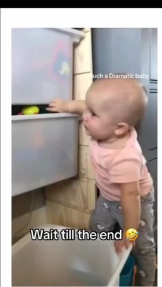 the baby is trying to get into the drawer