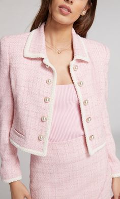 Bring a bit of shine to the season with the Lenore. Designed with strong shoulder padding, gold decorative buttons, braided trim and a splash of metallic fibers on pink and white tweed, this lined blazer is a summer layering essential. Pair with a button-up and pencil skirt to be best dressed at the office. Product Fit & Details Self: 57% Cotton, 21% Polyester, 13% Acrylic, 7% Polyamide, 1% Metallized Polyester, 1% Elastane Lining: 95% Polyester, 1% Elastane Hand wash, hang to dry or professiona Pink Professional Outfit, Pink Business Casual Outfits, Pink Closet Aesthetic, Pink Office Outfit, Pink Tweed Blazer Outfit, Light Pink Fashion, Light Pink Outfit, Cropped Tweed Blazer, Pink Tweed Jacket