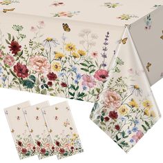 the table cloth has flowers and butterflies on it, along with three place mats for each piece