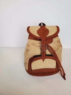 OUR BACKPACKS ARE 100% HANDMADE WITH PREMIUM LEATHER AND VINTAGE GUATEMALAN HUIPILES. EACH ONE OF A KIND BAG IS CUSTOM MADE BY FEMALE GUATEMALAN ARTISANS AND COMBINES MODERN STYLE WITH TIME TRADITIONAL TECHNIQUES.SLIGHT IMPERFECTIONS ARE TO BE EXPECTED AND APPRECIATED DUE TO THE HANDMADE NATURE OF OUR ITEMS 1 BAG ( 10" WIDTH X 13" LONG) Artisan Beige Travel Bag, Traditional Beige Travel Bag, Artisan Brown Backpack Shoulder Bag, Bohemian Beige Backpack, Casual Beige Fair Trade Shoulder Bag, Beige Satchel Backpack With Leather Handles, Bohemian Backpack In Natural Color For Everyday Use, Rectangular Brown Woven Backpack, Handmade Brown Standard Backpack