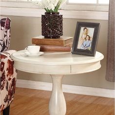 a white table with flowers and books on it