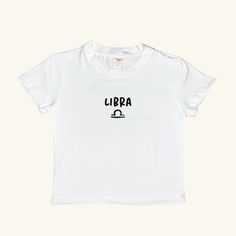 Elevate your summer wardrobe with our special collection of minimal and stylish Signs Baby Tees. This white tee, featuring the Libra, offers a perfect blend of comfort and style, making it an essential piece for everyday outfits. It's minimal design and basic fit ensure it pairs effortlessly with any look. This unique collection celebrates the signs, making it a thoughtful gift or a personal treat. Don't miss out on the other designs in this collection! Visit our shop, Minel, to explore all the collections and find your perfect match. Material: 80% Cotton 20% Lycra Basic Summer T-shirt, Minimalist Crew Neck T-shirt For Summer, White Print T-shirt For Summer, Organic Cotton T-shirt For Everyday Summer Wear, Unisex Organic Cotton T-shirt For Summer, Basic Short Sleeve T-shirt For Summer, Basic White T-shirt For Everyday, Minimalist Short Sleeve T-shirt For Summer, Summer Crew Neck Cropped T-shirt