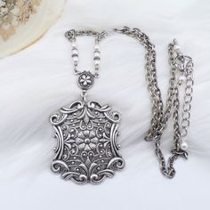 This NEW (made to look old) necklace was handmade by ME and is made to look like a Vintage treasures from the past.  The stunning focal pendant is a very intricate European style German made antique silver plated brass rectangular shaped piece that features very detailed floral and filigree scrollwork patterns on the front side.  It is so well done and filled with gorgeous details.  The back is HOLLOW and is shown n the listing pictures.  I have also added a floral silver plated connector and wh Scrollwork Pattern, Ella Enchanted, Jewelry Victorian, Brass Texture, Art Nouveau Style, Necklace White, Fancy Jewelry, Silver Filigree, Silver Chain Necklace