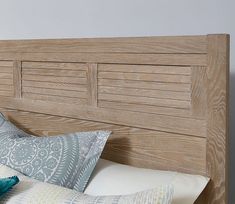 a wooden headboard with two pillows on it