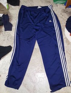 Nice pair of vintage Adidas tear away basketball sweatpants in men's size large. These pants have snap on buttons that run all the way down the pants. On both sides of the pants I did picture where the button at the top is missing. Overall the pants are in very good condition, judge for yourself. The pants also have pockets and a zippered back pocket. You can tell its vintage because Adidas no longer has tags that look like that. Here's your chance to own a sweet pair of pants that cannot be fou Adidas Relaxed Fit Sweatpants With Three Stripes, Adidas Stretch Sweatpants For Streetwear, Blue Adidas Athleisure Pants, Casual Blue Adidas Bottoms, Adidas Blue Sweatpants For Jogging, Blue Adidas Bottoms For Jogging, Adidas Logo Cotton Jogging Pants, Adidas Cotton Jogging Pants, Cotton Adidas Logo Pants For Jogging