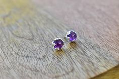 These Stunning Amethyst  nature inspired cute studs earrings are made of 925 silver and natural African amethyst , The quality of the amethyst i use are a stellar quality.These beautiful Deep purple leaf earrings features a 8 MM Natural amethyst smooth cabochon all held together by 925 sterling silver , Its simplistic design wont hamper your day to day activity and will look absolutely gorgeous on You.******************** If the quality of the stones matters to you than you are at right place be Cute Stud Earrings, Amethyst Studs, Opal Wedding Rings, Crystal Therapy, Birthstone Earrings, Simplistic Design, Earrings Cute, Studs Earrings, Birthstone Earring