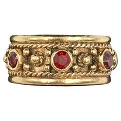 Ornate Renaissance style 14K yellow gold garnet set band ring Late 19th Century Marks: Marker's mark A within a shield, 14K Technique: Twisted gold wire work, granulation, cullet set gemstones Size: 5.75 US Very Good Condition Very fine quality, intricate design and excellent workmanship, Hand crafted by an expert jeweler, this beautiful band is fit for a Renaissance princess or prince. A well rendered maker's mark on the interior of the letter A within a shield shaped crest. The garnets, rich vibrant red in color, faceted, cullet set. An ancient gemstone, garnet has been revered by the Egyptians, Greeks, Romans, Anglo-Saxons, Medieval Crusaders, Hunza warriors, Kings and Queens. It has historically been associated with the heart, inner fire, love, friendship and vitality. Amulets using th Red And Gold Ring, Antique Wedding Bands, Medieval Rings, Garnet Jewelry, Fame Dr, Ancient Jewelry, Gold Band Ring, Amulets, Maker's Mark