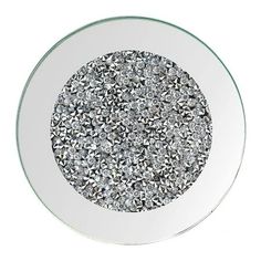 a round glass plate with silver and white designs on the rim, in front of a white background