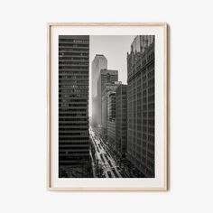 black and white photograph of city buildings in new york, usa framed in wood frame