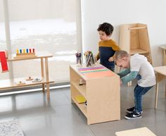 two children playing with toys in a playroom