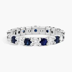 a white gold ring with blue and white stones on the side, set in 18k white gold