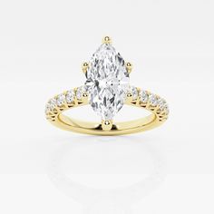 a yellow gold engagement ring with an oval cut diamond in the center and side stones