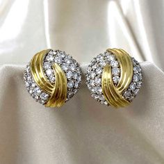 A stunning pair of vintage clip-on earrings featuring a cluster of round brilliant cut diamonds and an abstract gold design. The earrings follow a round shape and were made in 18k yellow gold circa 1970. The total approximate diamond weight of these earrings is 8.50 carats, H-I color, VS2-SI1 clarity. The measurements of these earrings are 25mm. The backs are 14k yellow gold clip-on and have posts. The posts can be removed. If you have any questions about the Rustburg earrings, please feel free Luxury Gold Diamond Statement Earrings, Luxury Vintage Brilliant Cut Earrings, Luxury Classic Yellow Gold Cluster Earrings, Luxury Yellow Gold Cluster Earrings With Vvs Clarity, Traditional Luxury Yellow Gold Diamond Earrings, Yellow Diamond Earring, Vintage Diamond Earrings, Fancy Diamond Ring, Estate Diamond Jewelry