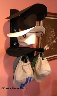 three hats and two purses hanging on a rack