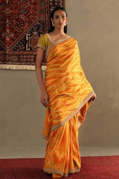 Yellow silk saree featuring sequin embellished border on an abstract patterned base. Comes with unstitched blouse fabric. - Aza Fashions Cotton Silk Pre-draped Saree With Mirror Work, Anarkali Pre-draped Saree With Gota Work In Cotton Silk, Designer Silk Pre-draped Saree For Festivals, Festive Silk Pre-draped Saree With Mirror Work, Transitional Yellow Chanderi Pre-draped Saree, Fitted Pre-draped Tussar Silk Saree With Dupatta, Transitional Raw Silk Pre-draped Saree With Gota Work, Yellow Pre-draped Saree With Resham Embroidery For Transitional Seasons, Silk Pre-draped Saree With Gota Work For Diwali